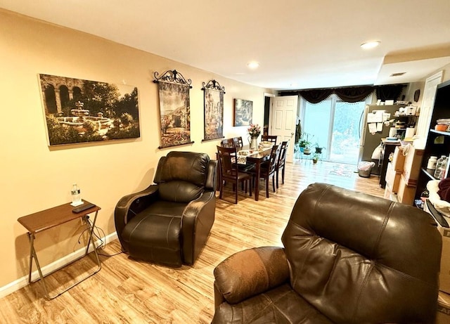 living room with baseboards, recessed lighting, and wood finished floors