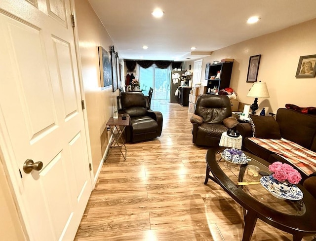 living room with recessed lighting and light wood-style flooring