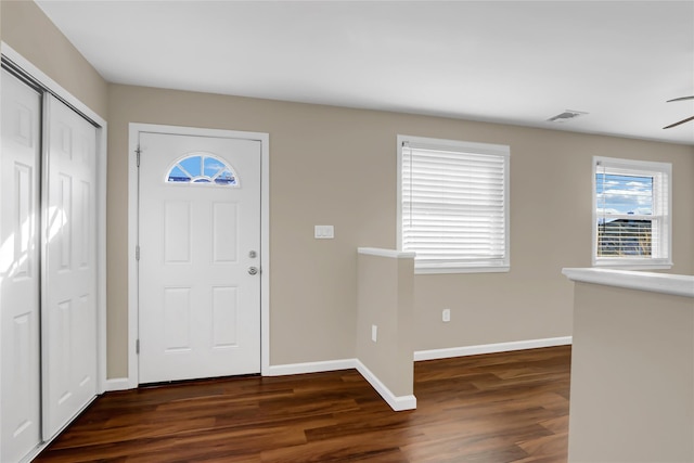 foyer entrance with ceiling fan and dark hardwood / wood-style flooring