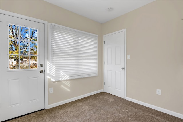 doorway featuring light carpet