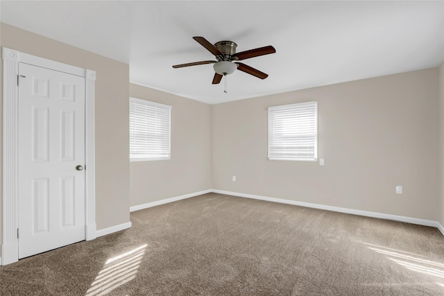 spare room with carpet, plenty of natural light, and ceiling fan