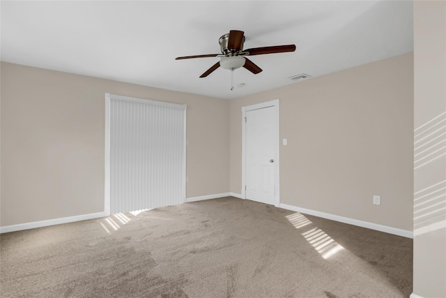 empty room with ceiling fan and carpet floors