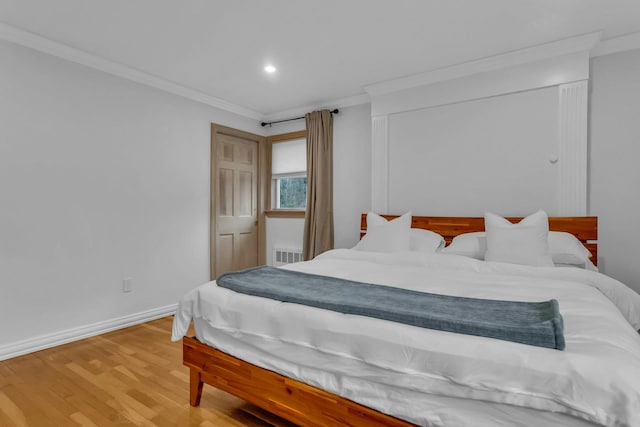 bedroom featuring hardwood / wood-style floors and crown molding