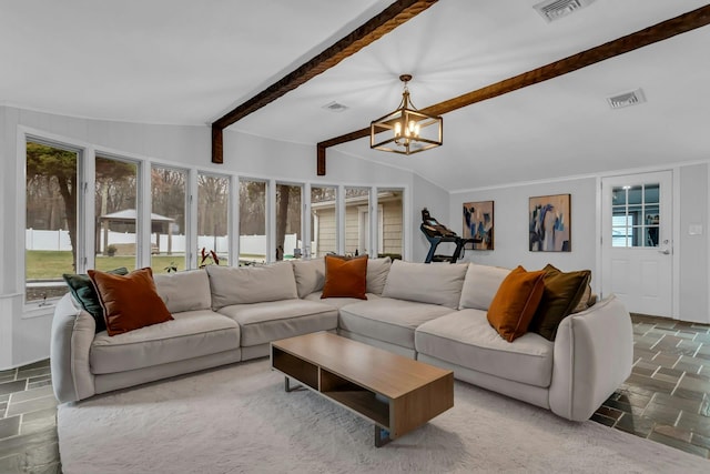 living room with a chandelier, a wealth of natural light, and lofted ceiling with beams