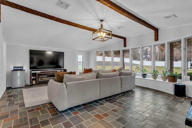 living room featuring vaulted ceiling with beams, a wealth of natural light, and a notable chandelier