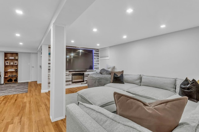 living room featuring a fireplace and light hardwood / wood-style flooring