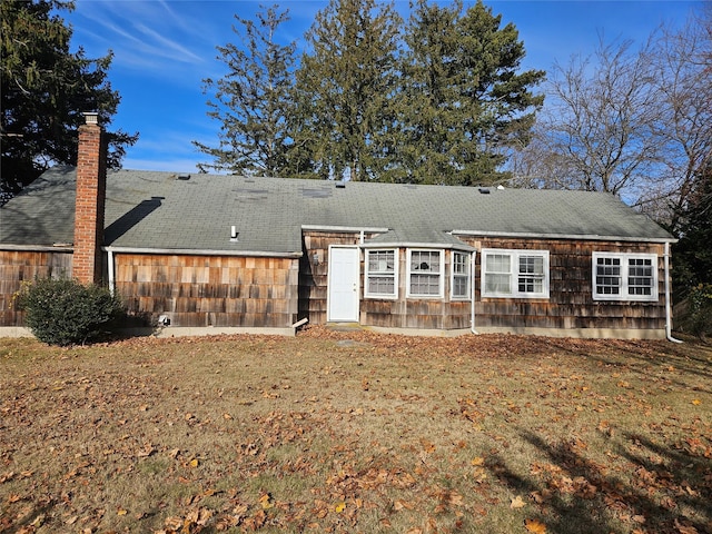 back of house featuring a yard