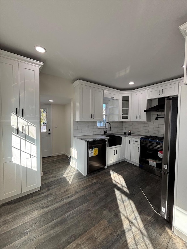 kitchen with dishwasher, a sink, dark wood finished floors, and black gas range oven