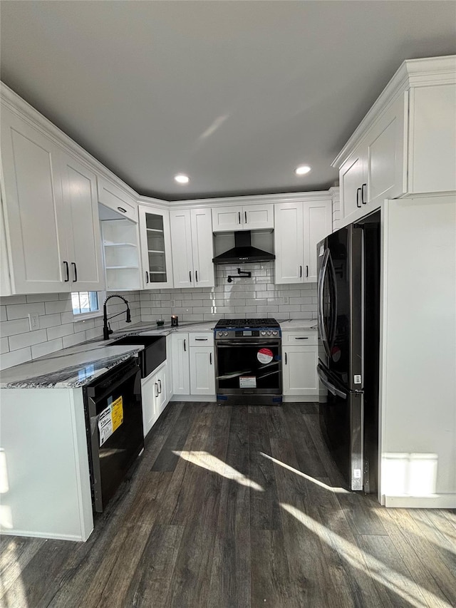 kitchen featuring stainless steel gas stove, dishwasher, backsplash, range hood, and a sink