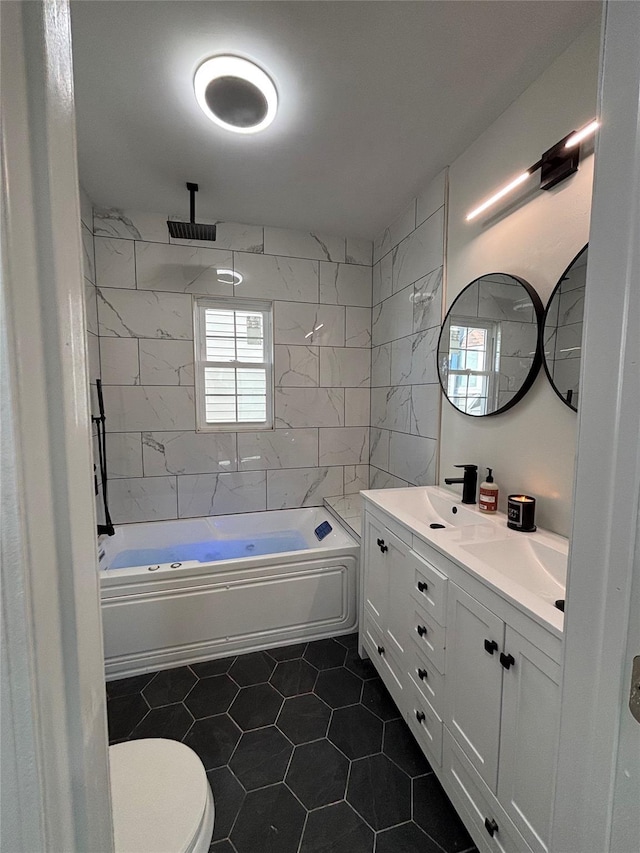 bathroom featuring double vanity, a sink, toilet, and a combined bath / shower with rainfall shower