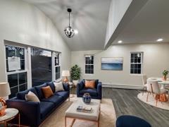 living room featuring an inviting chandelier, vaulted ceiling, wood finished floors, and recessed lighting