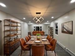 dining room featuring baseboards, a baseboard heating unit, and recessed lighting