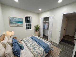 bedroom featuring baseboards, wood finished floors, and recessed lighting