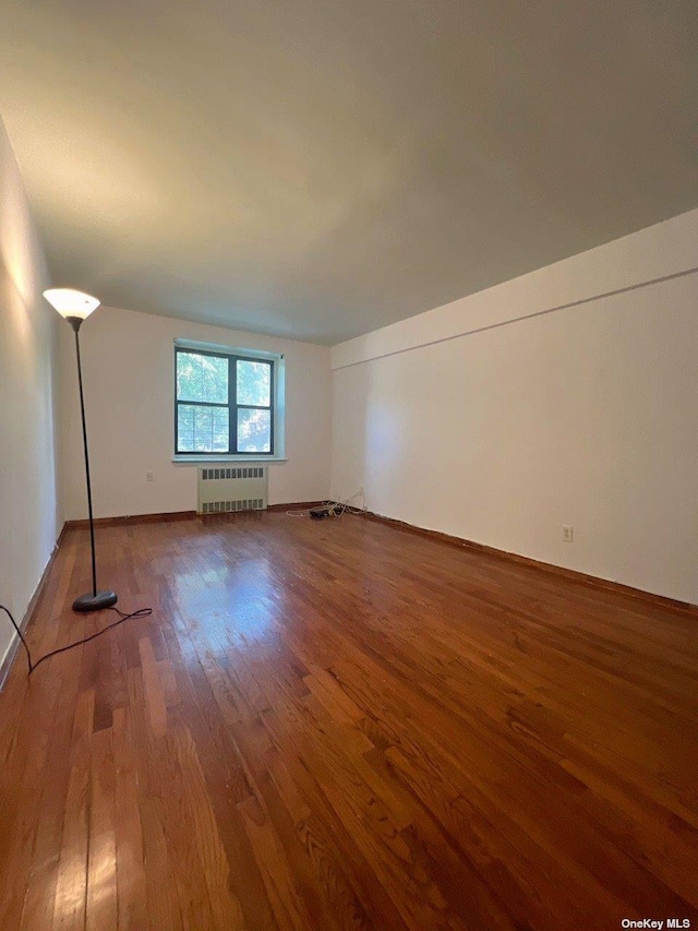 interior space featuring hardwood / wood-style floors and radiator heating unit