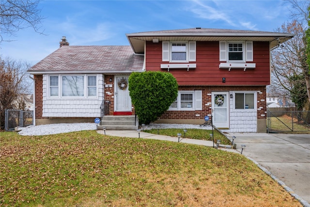 tri-level home with a front yard