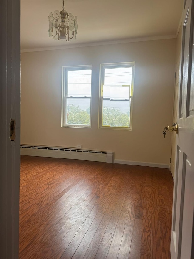 95-07 239th St, Floral Park, NY 11001 - unfurnished room with a baseboard heating unit, a chandelier, crown molding, wood finished floors, and baseboards