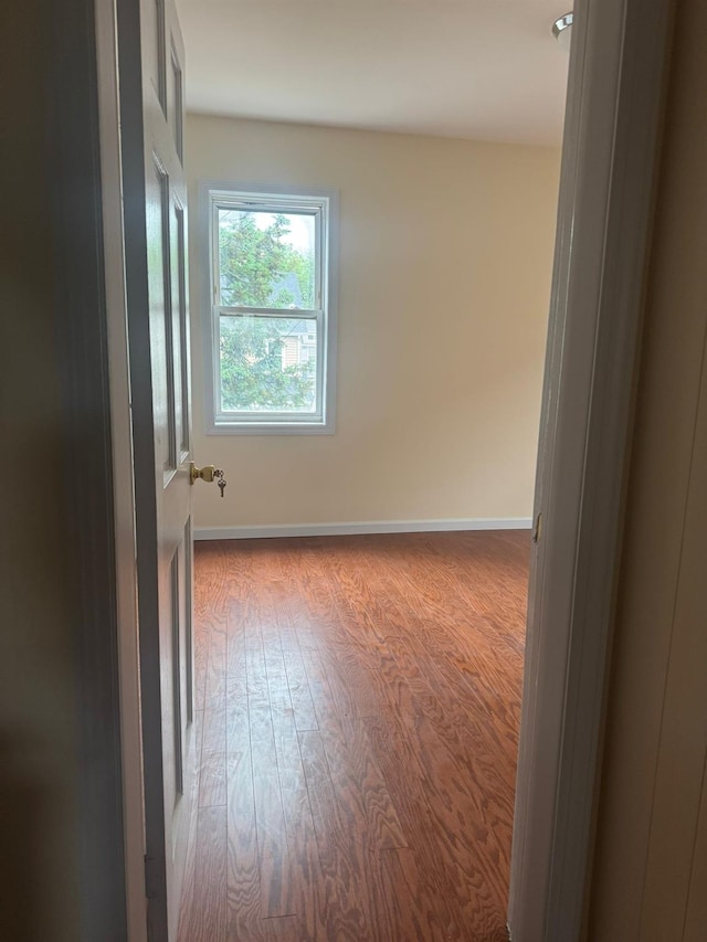 95-07 239th St, Floral Park, NY 11001 - empty room featuring wood finished floors and baseboards