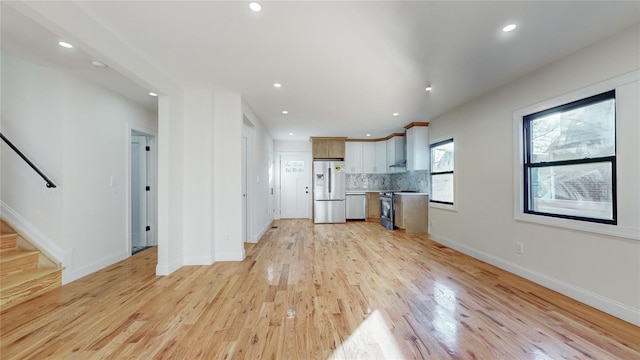 unfurnished living room with light wood-type flooring