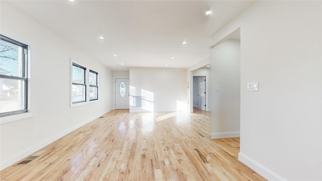 empty room with light hardwood / wood-style flooring