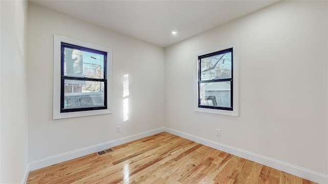 spare room with hardwood / wood-style flooring