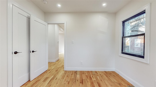 unfurnished room with light hardwood / wood-style flooring