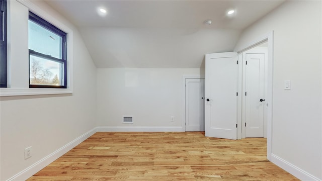 bonus room featuring light hardwood / wood-style floors and vaulted ceiling