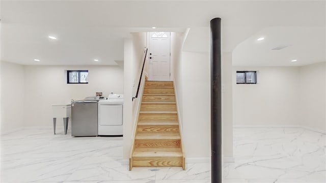 stairs featuring separate washer and dryer