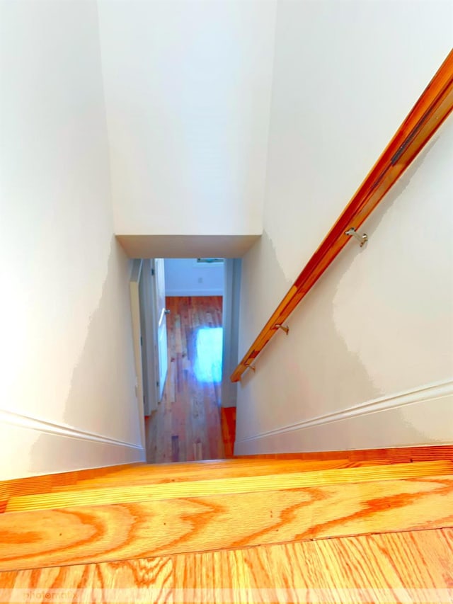 stairs featuring hardwood / wood-style floors