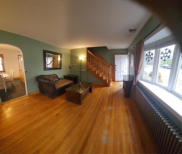 living room featuring light hardwood / wood-style floors and radiator heating unit