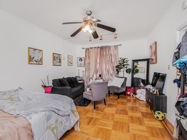 bedroom featuring ceiling fan and parquet flooring