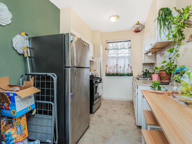 kitchen with sink, white cabinets, and stainless steel appliances