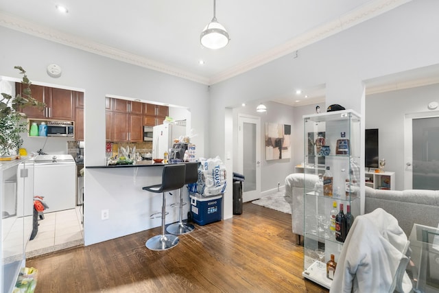 kitchen with backsplash, white fridge, crown molding, and dark wood-type flooring