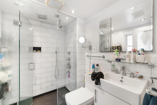 bathroom featuring vanity, an enclosed shower, and toilet