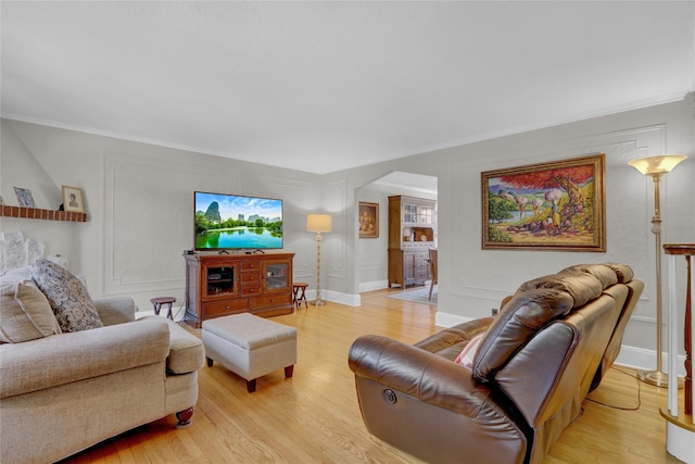 living room featuring light hardwood / wood-style floors and ornamental molding