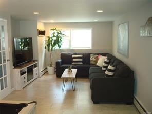 living room with a baseboard heating unit