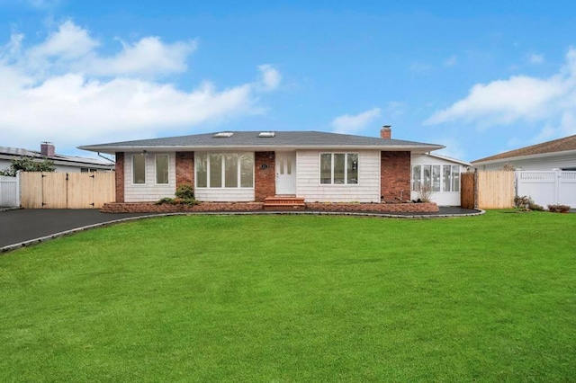 ranch-style home featuring a front lawn