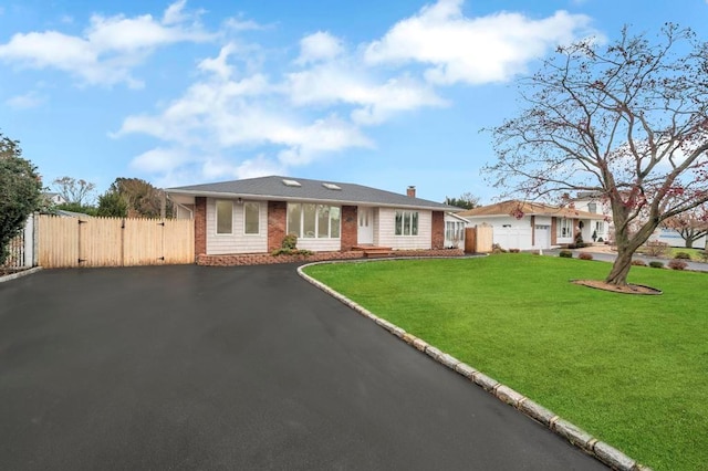 ranch-style home with a front lawn and a garage