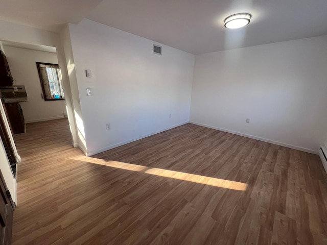 unfurnished room with dark hardwood / wood-style floors