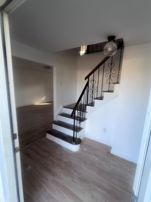 stairs with hardwood / wood-style flooring