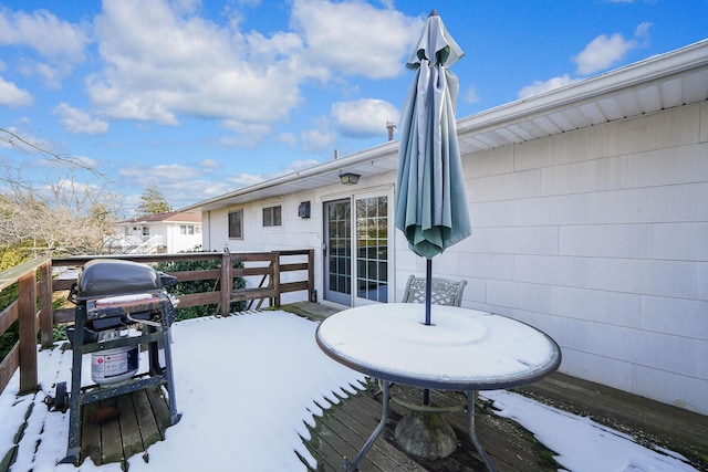 snow covered deck featuring grilling area