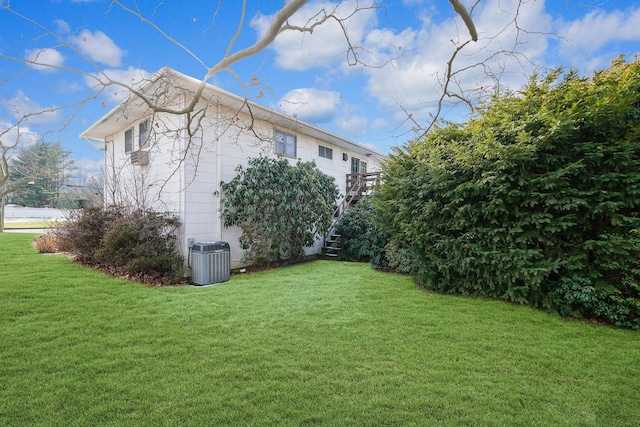 view of home's exterior with a lawn and central air condition unit