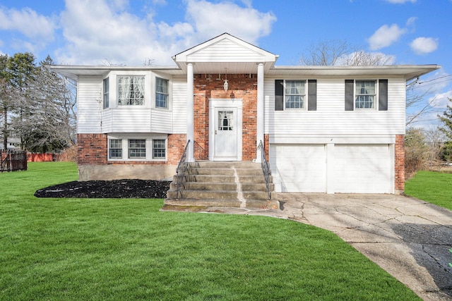 bi-level home with a garage and a front lawn