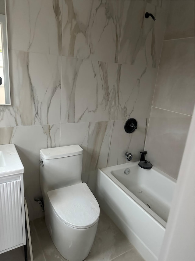 full bathroom with shower / tub combination, vanity, toilet, and tile walls