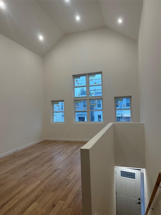 interior space featuring hardwood / wood-style flooring and high vaulted ceiling