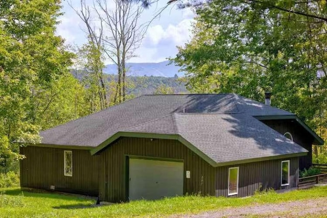 exterior space featuring a mountain view, a garage, and an outdoor structure