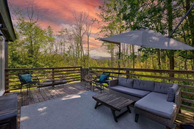 patio terrace at dusk with an outdoor living space and a deck