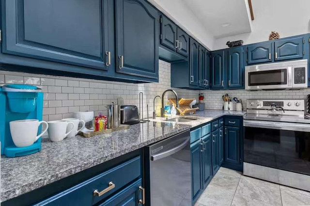kitchen featuring blue cabinetry, decorative backsplash, stainless steel appliances, and sink