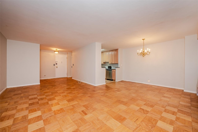 unfurnished living room featuring light parquet flooring and an inviting chandelier