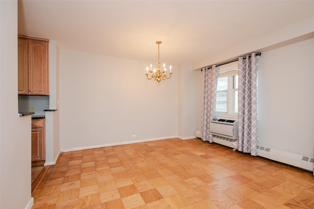 empty room with a wall mounted air conditioner, a notable chandelier, baseboard heating, and light parquet flooring