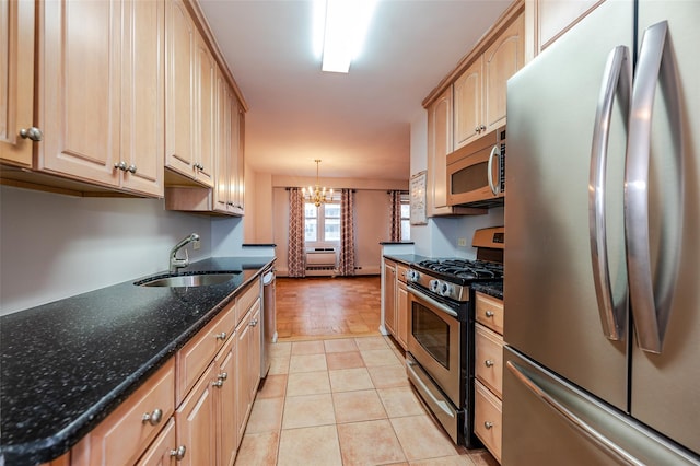 kitchen featuring sink, stainless steel appliances, a notable chandelier, dark stone countertops, and pendant lighting